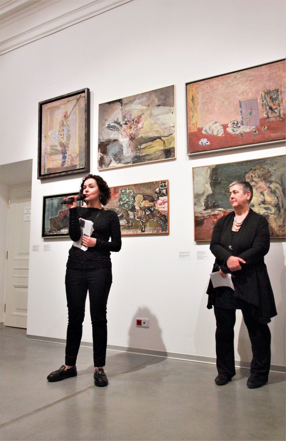 Wernisaż wystawy "(Nie)obowiązkowe nauczanie kapizmu", Przemawia Katarzyna Jankowska-Cieślik, obok stoi dr. Jolanta Gola, w tle widok wystawy