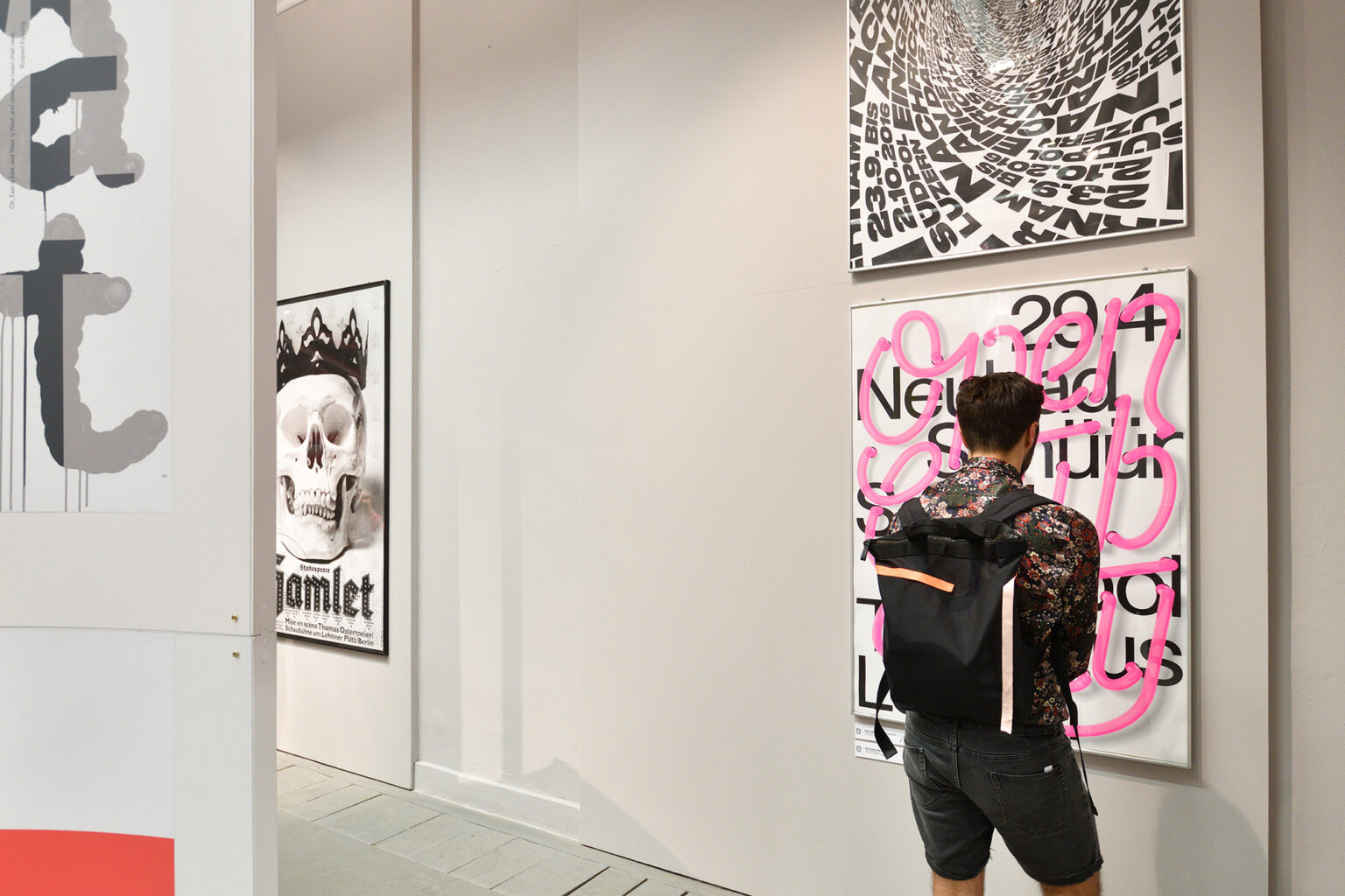 Postać oglądająca plakaty na wystawie