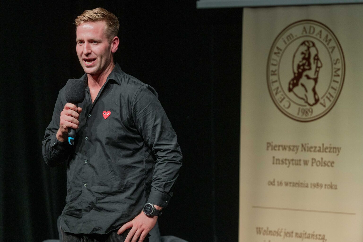 młody mężczyzna mówi do mikrofonu