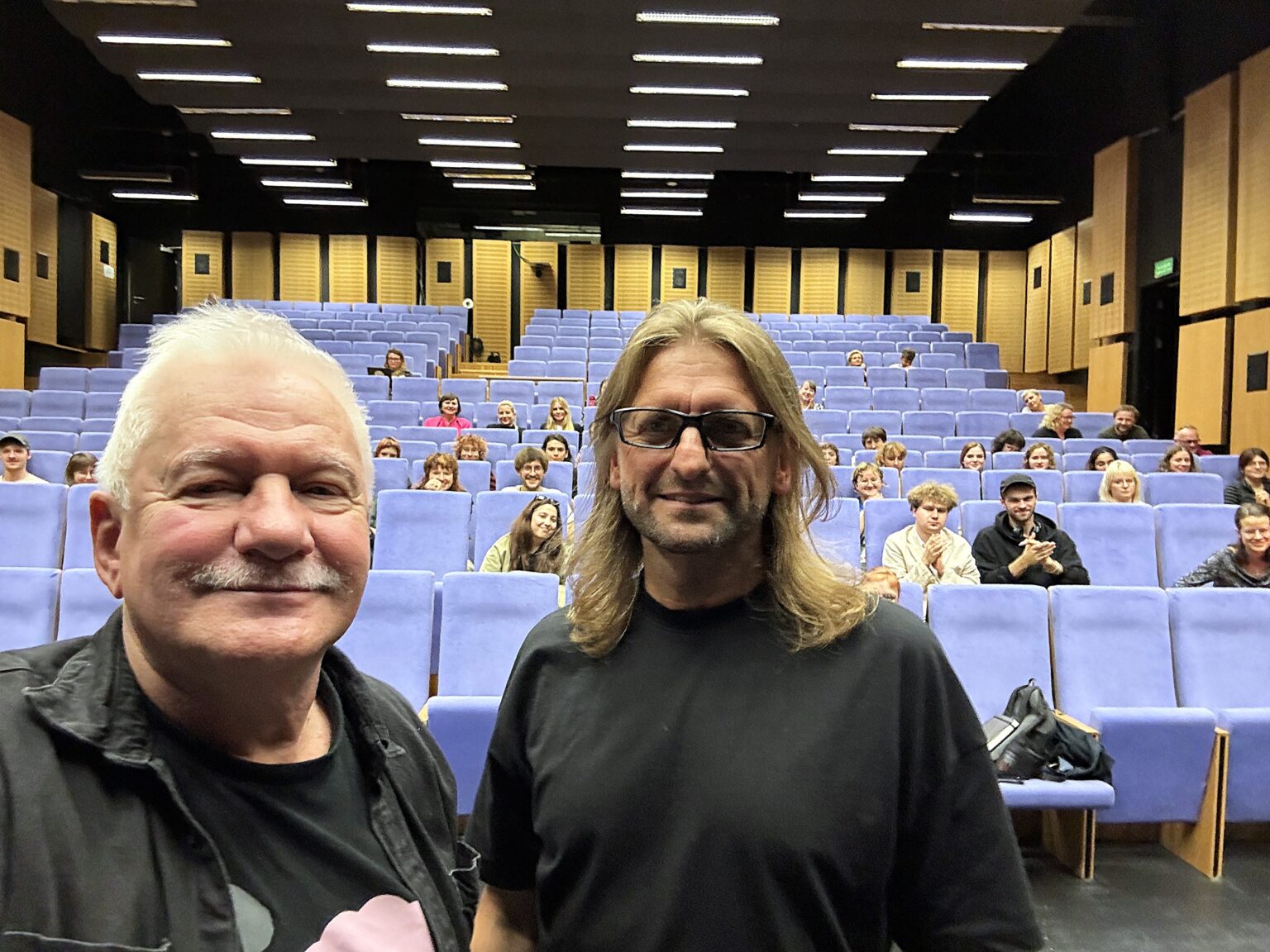 selfie: dwaj mężczyźni, w tle aula wykładowa