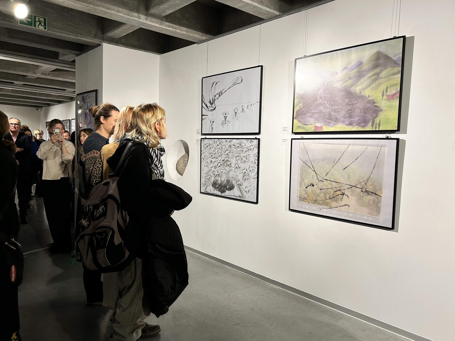 zwiedzający oglądają prace na wystawie