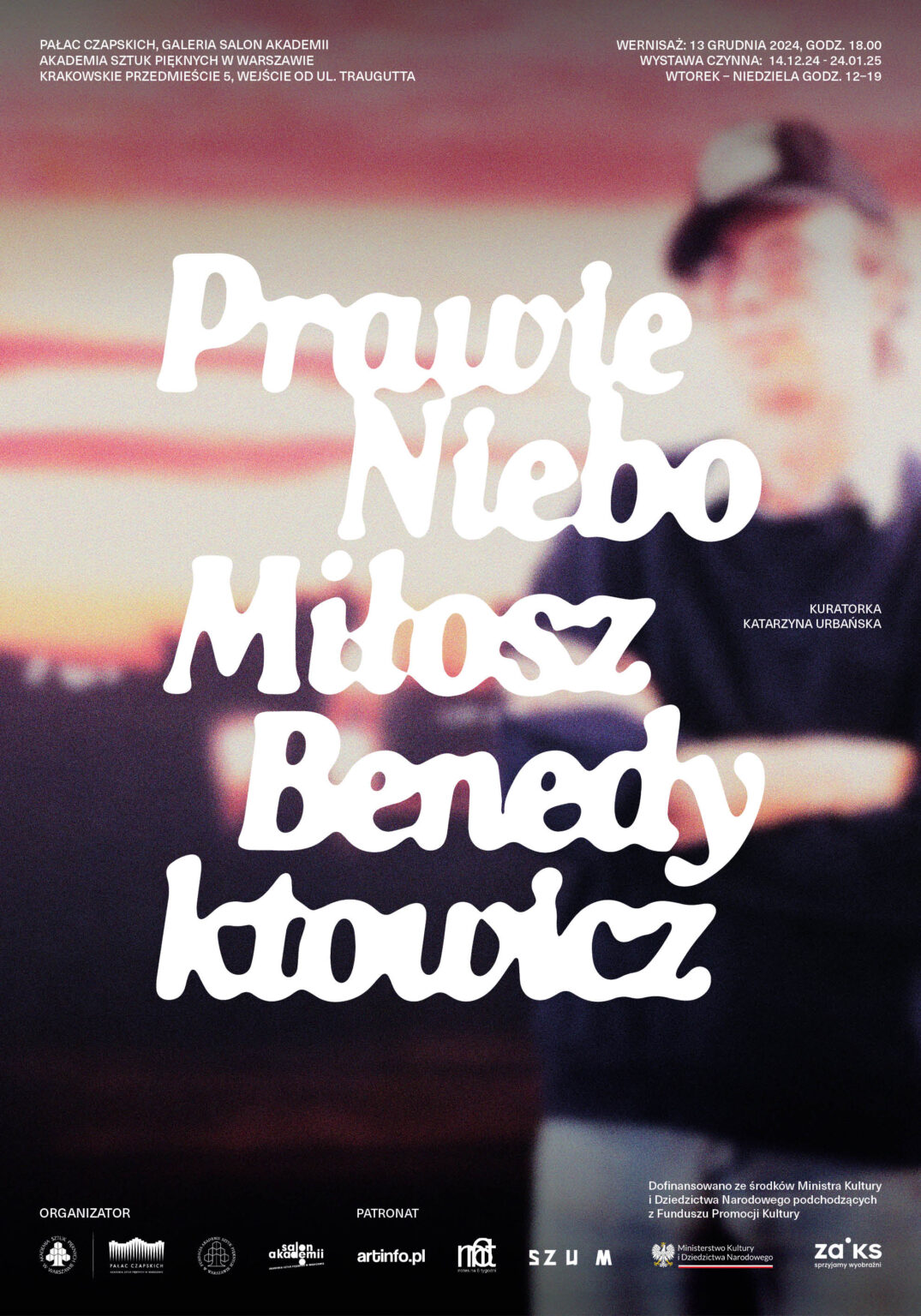 plakat w białym liternictwem, w tle rozmyta postać