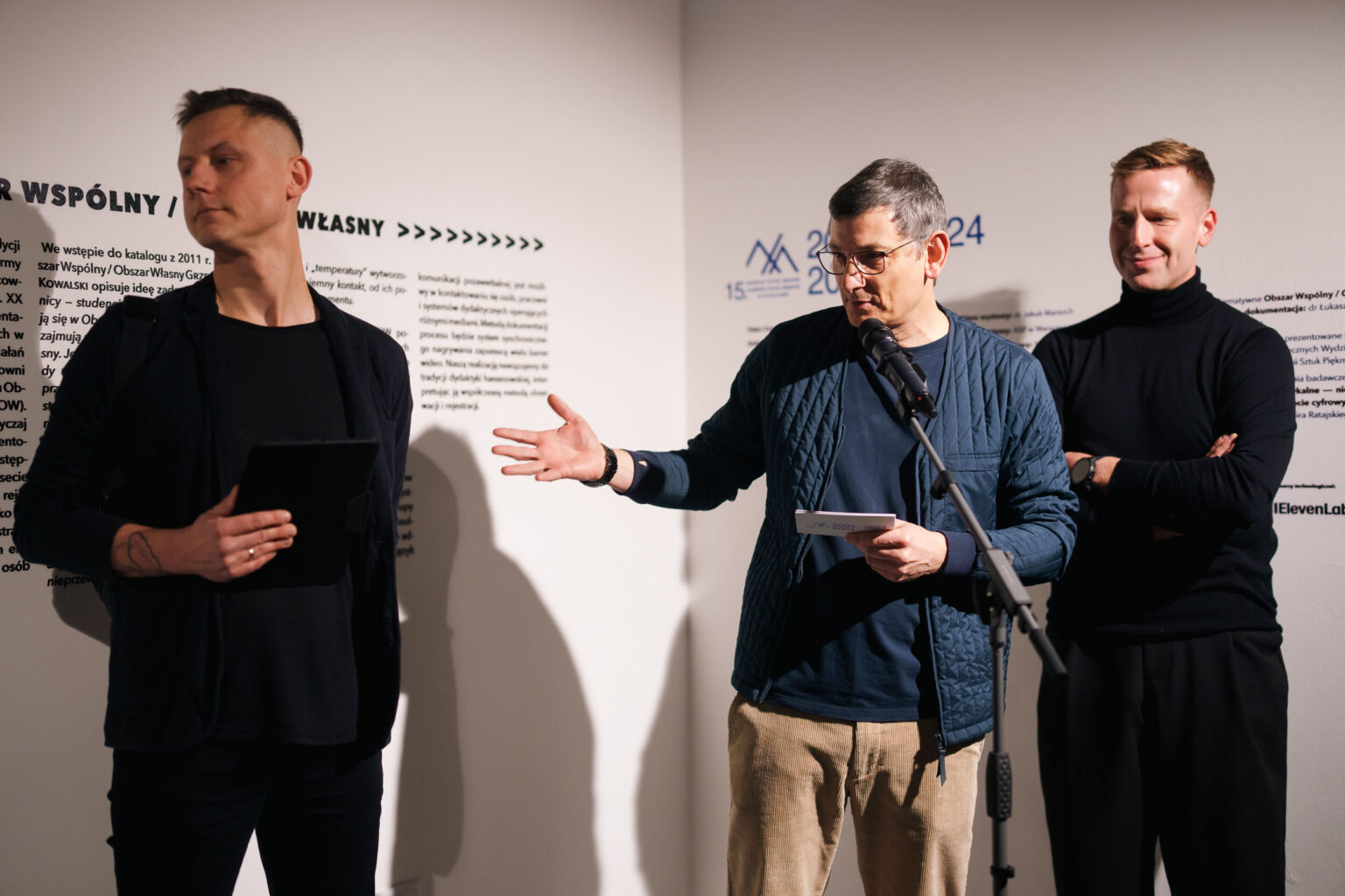 mężczyzna gestykuluje, przy mikrofonie